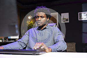 Man in living room playing engaging video games on gaming PC at computer desk