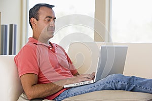 Man in living room using laptop