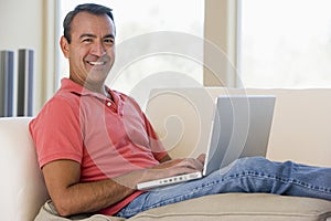Man in living room using laptop