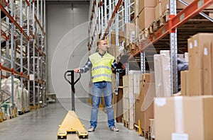 Man with loader and clipboard at warehouse