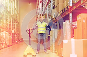 Man with loader and clipboard at warehouse