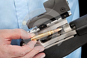 Man loading assault rifle