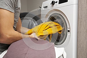 Man loading the washer dryer