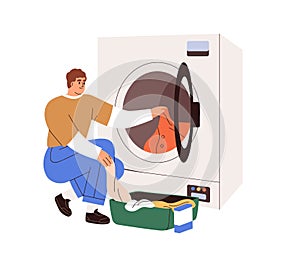 Man loading washing machine with dirty clothes. Person putting linen into washers drum. Guy opening door of