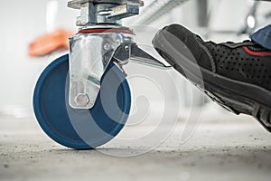 Man Locks Scaffold Wheels For Safety photo