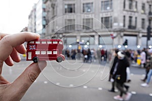 Man with a londoner red double-decker bus