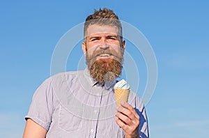 Man with long beard enjoy ice cream. Sweet tooth concept. Man with beard and mustache on smiling face eats ice cream