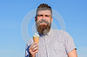 Man with long beard enjoy ice cream. Sweet tooth concept. Man with beard and mustache on smiling face eats ice cream