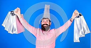 Man with long beard and funny look isolated on blue background. Hipster with trendy beard shopping during seasonal sales