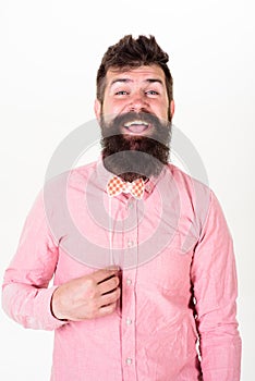 Man with long beard holding red paper bowtie. Bearded man smiling on white background. Hipster in pink shirt with trendy