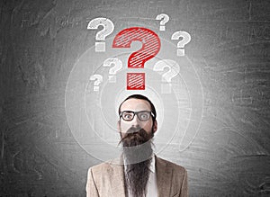 Man with long beard and question marks