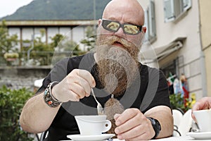 a man with long beard, drinking, enjoys a cup of coffee, Cappucino