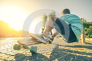 Man on longboard at sunset