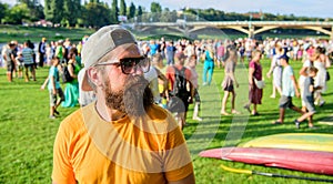 Man look through sunglasses sunny day outdoors. Urban event celebration. Man bearded hipster in front of crowd people