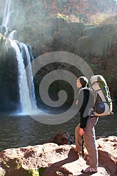 Man look on waterfall