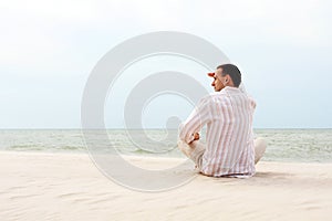 Man looking afar near the sea