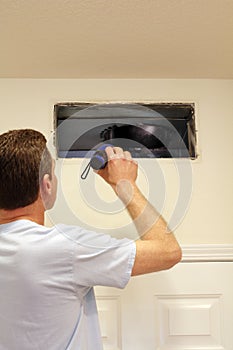 Man Looking into Air Duct photo