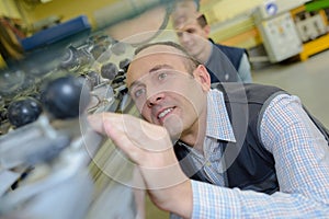 Man looking appreciatively at metal surface