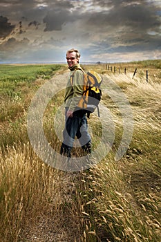 Man looking back and smiling on a country road photo