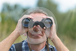 Man looking through binocular