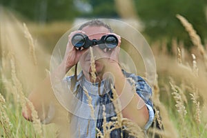 Man looking through binocular