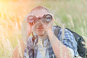 Man looking through binocular