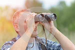 Man looking through binocular