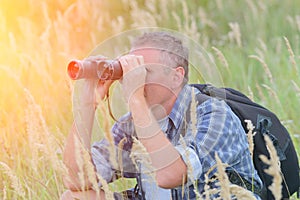 Man looking through binocular