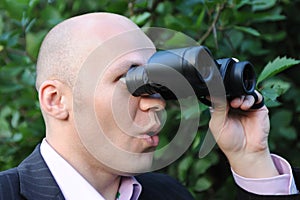 Man looking through binoculars