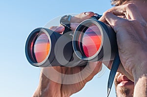 A man looking through the binoculars photo