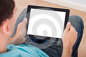 Man looking at blank screen of digital tablet