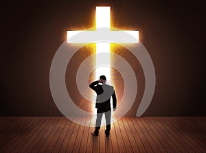 Man looking at bright cross sign