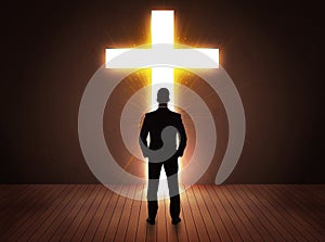 Man looking at bright cross sign