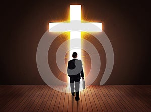 Man looking at bright cross sign