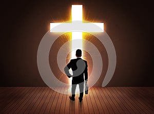 Man looking at bright cross sign