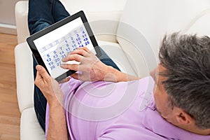 Man looking at calendar in digital tablet