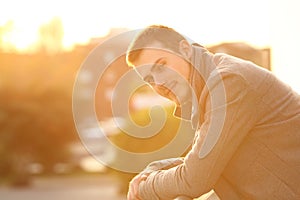 Man looking at camera in a balcony in winter
