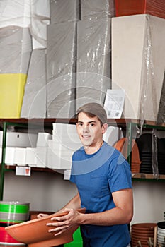 Man looking at the camera buying a flower pot