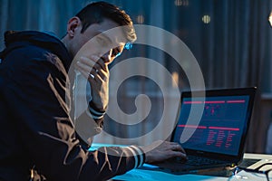 Man looking in the camera. Hacker attacks and stealing access databases with passwords. Cyber security