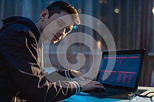 Man looking in the camera. Hacker attacks and stealing access databases with passwords. Cyber security