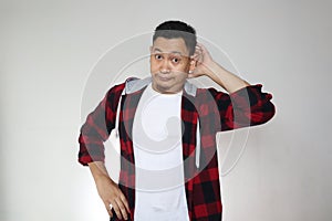 Man looking at camera with ignorant gesture, sratching head in confusion photo