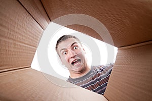 Man looking into cardboard box