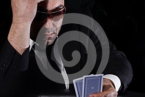 Man looking at cards in casino