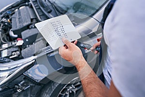 Man looking at colour codes for paint on cards flipside