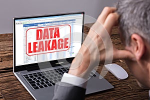 Man Looking At Computer Screen With Data Leakage Message