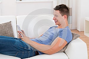 Man Looking At Digital Tablet