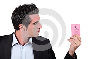 Man looking at driving licence