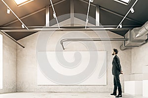 Man looking at empty billboard