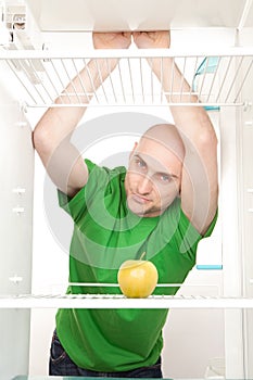 Man looking in empty fridge