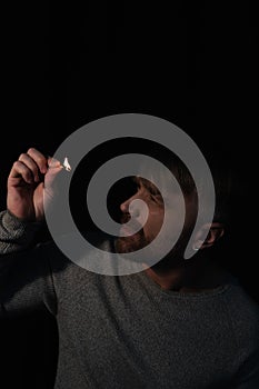 man looking at flame of burning